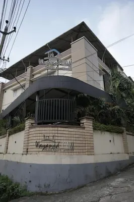 a building with graffiti on the side of it at Wayanad Cliff Hotel Apartments in Kalpetta