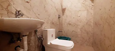 a bathroom with a sink and a toilet at Anya Paradise in Ooty