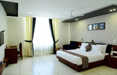 a hotel room with a bed and a television at HOTEL JAAS CONTINENTAL in Edappāl