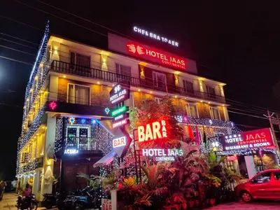 a building with neon signs on the side of it at HOTEL JAAS CONTINENTAL in Edappāl