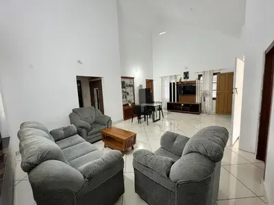 a living room with two couches and a table at Springfield service villa in Mananthavady