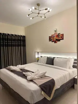 a bedroom with a large white bed with a chandelier at Ponmari Villa in Ooty