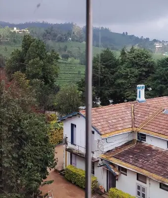 a view of a house in a village at Belair cottages in Kotagiri