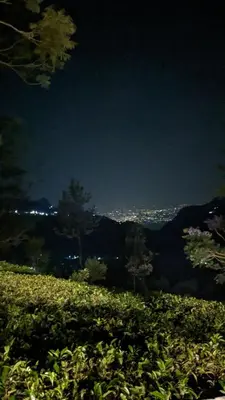 a view of a field with a city in the background at Moksha at Infinity Valley in Kotagiri