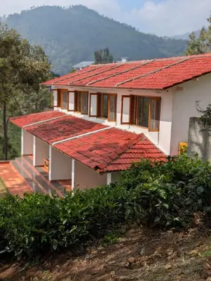 a house with a red roof at Moksha at Infinity Valley in Kotagiri