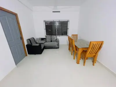 a room with a table and chairs and a couch at CITY APARTMENTS in Guruvāyūr