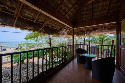 a balcony with a view of the beach at Maliekal Heritance Cherai Beach Cochin in Cherai Beach