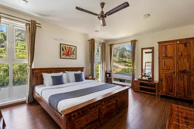 a bedroom with a large bed and windows at Kalpavriksha 4BR Luxury Villa - Xplore Indo in Kotagiri