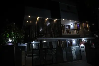 a building with lights on it at night at Malpans Mansion Villa in Nedumbassery