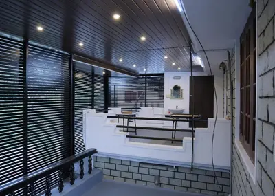 a bathroom with a table and benches in a building at Malpans Mansion in Nedumbassery