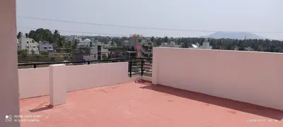 a balcony with white walls and a view of a city at Kailash Guest Home in Mysore