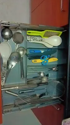 a drawer filled with lots of kitchen utensils at Kailash Guest Home in Mysore