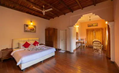 a bedroom with a bed and a table in it at Misty Heights by The Sanihara in Vayittiri