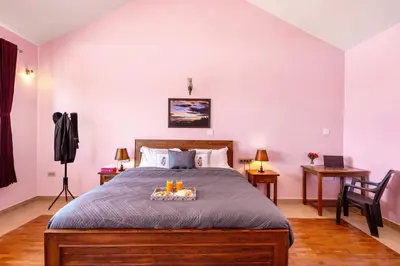 a bedroom with a bed with a tray of candles on it at StayVista at 5 Rooms at The West Wind - Ooty Comp Breakfast in Ooty