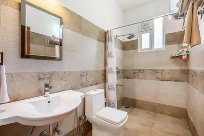 a bathroom with a sink and a toilet at StayVista at 5 Rooms at The West Wind - Ooty Comp Breakfast in Ooty