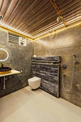 a bathroom with a toilet and a shower and a sink at Kaadgal Resort in Kanakapura