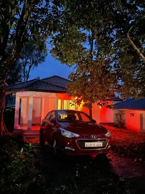 a car parked in front of a house at night at Spicy Nest Resort in Pinangode