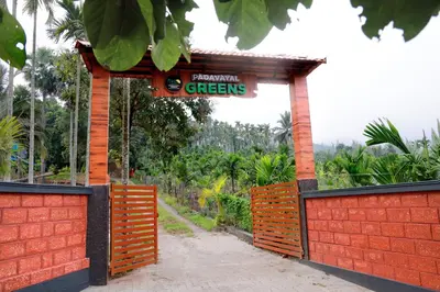 a sign that reads greengrocers on a red fence at PADAVAYAL GREENS in Attappādi