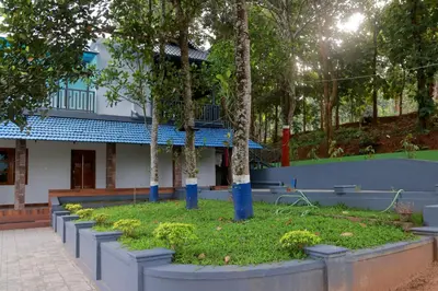 a row of trees in front of a building at PADAVAYAL GREENS in Attappādi