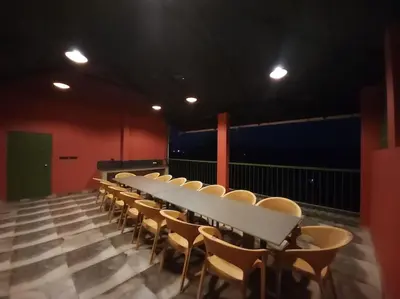a long white table and chairs in a room at Gulzar 2BHK Service Apartment, kannur in Kannur