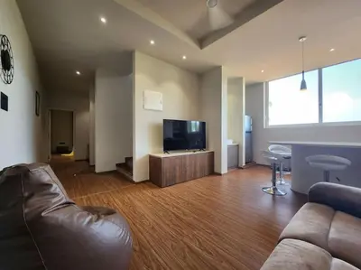 a living room with a couch and a flat screen tv at Gulzar 2BHK Service Apartment, kannur in Kannur