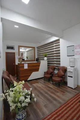 a waiting room with chairs and a reception desk at Richfields in Ooty