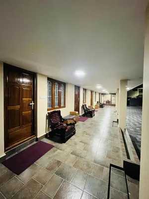 a hallway with chairs and a door in a building at The Tendoinn in Pollāchi