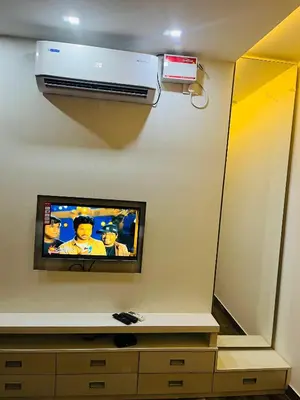 a tv on a wall in a room at The Tendoinn in Pollāchi