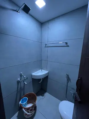 a bathroom with a toilet and a sink at The Tendoinn in Pollāchi