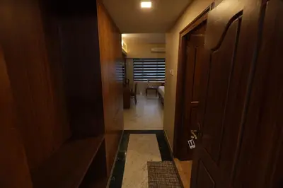 a hallway with a door leading to a room at Liwa Tower Hotel & Business Center in Kunnamkulam