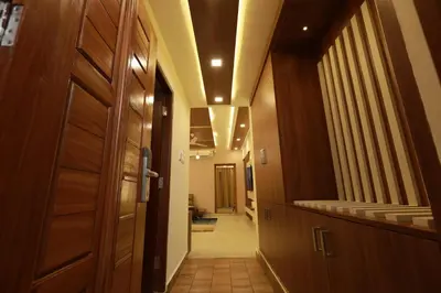 a hallway leading to a room with a door at Liwa Tower Hotel & Business Center in Kunnamkulam