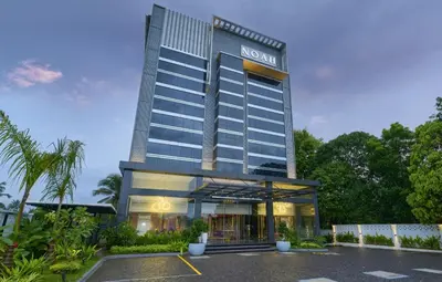 a hotel with a parking lot in front of it at Noah Sky Suites in Cochin