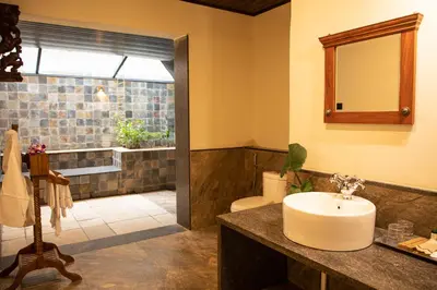 a bathroom with a sink and a toilet and a shower at Akshaya Bungalow by Sparsa in Sethumadai
