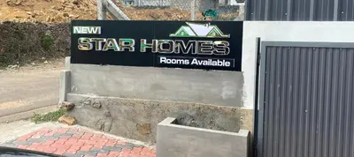 a star homes sign on the side of a building at New star homes in Kotamangalam