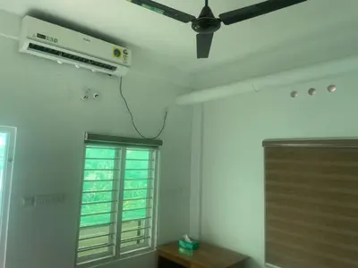 a room with a ceiling fan and a window at New star homes in Kotamangalam