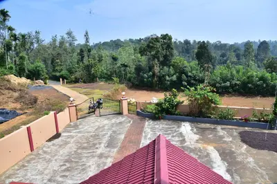 a person standing on top of a bridge at Madhuvana Homestay Coorg in Madikeri