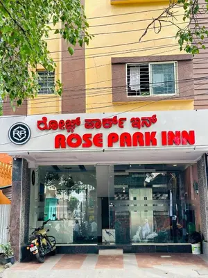 a rose park inn sign in front of a store at ROSEPARK INN in Mysore