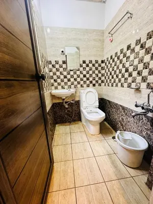 a bathroom with a toilet and a sink at ROSEPARK INN in Mysore