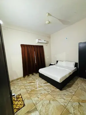 a bedroom with a white bed and a window at ZAHIR RESIDENCY in Kondotti