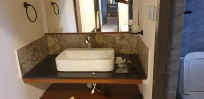 a sink in a bathroom with a mirror at Vue D'en Haut, Ooty,India in Ooty