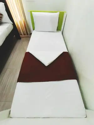 a couple of beds in a room at Dreamnest Residency in Kalpetta