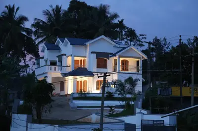 a white house with its lights on at Dreamnest Residency in Kalpetta