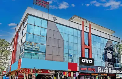 a building with a sign on the side of it at Hotel O Easy Stay Mysore in Mysore