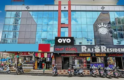 a building with motorcycles parked in front of it at Hotel O Easy Stay Mysore in Mysore