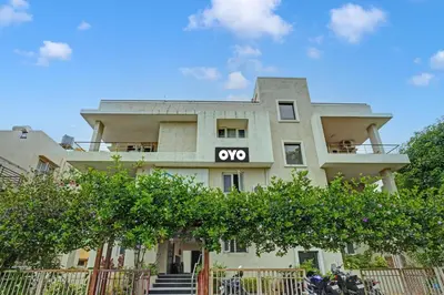 an apartment building with an xo sign on it at Super Hotel O Indra Suites in Mysore