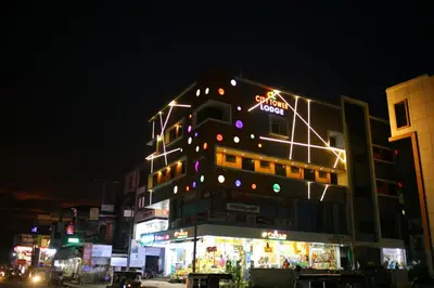 a building with a sign on top of it at night at City Tower Lodge in Nilambūr