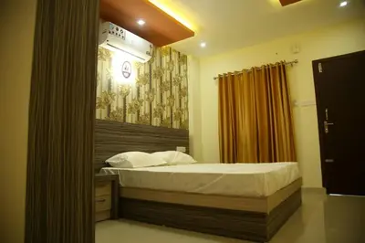 a bedroom with a bed in a room with a curtain at City Tower Lodge in Nilambūr