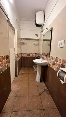 a bathroom with a sink and a mirror at RAATREE in Mysore
