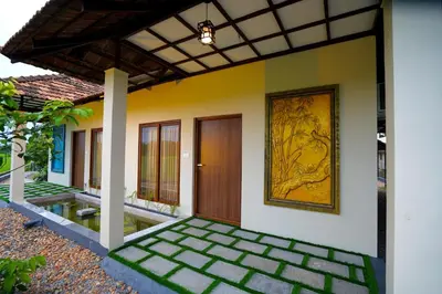 a front door of a house with a painting on the wall at KOTTACKAL NATURE INN in Nedumbassery