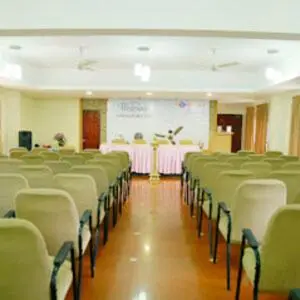 a room with rows of chairs and a white board at Kottaram Hotels Ottaplam in Palakkad